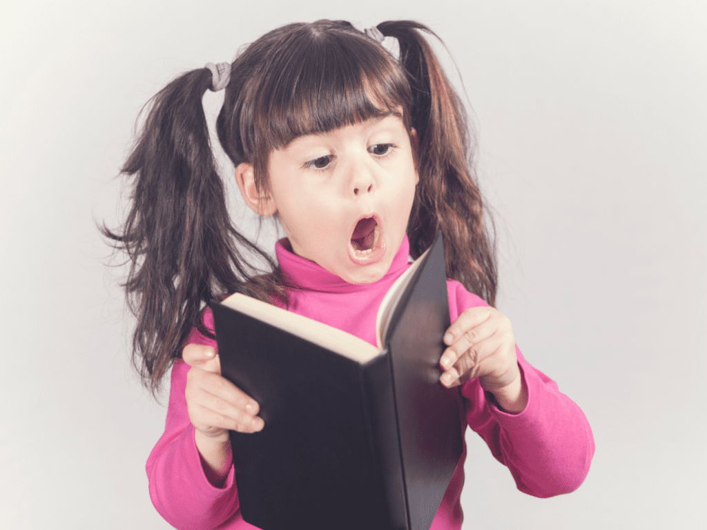 6 Types of Literacy Students Need for the 21st-Century (That Aren't Reading) 2 Child reading a book with a surprised face