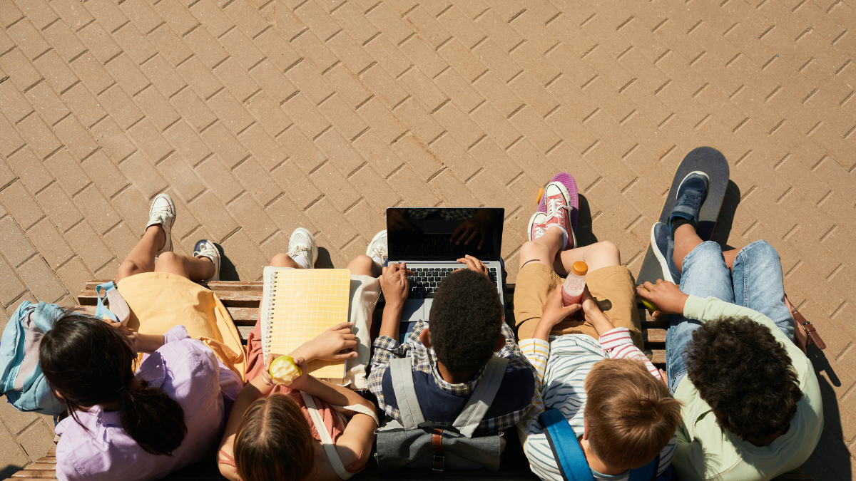 aerial view of students studying with laptops and notebooks for education systems around the world