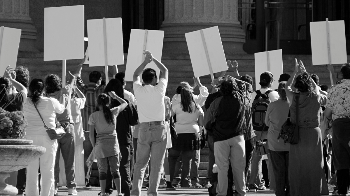 People protesting an unknown issue on the steps of a government building for a blog post about teaching controversial issues