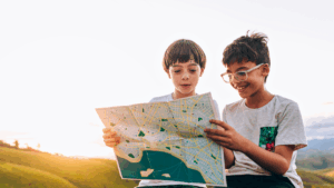 Two boys holding a map for blogpost about Map Skills for Kids